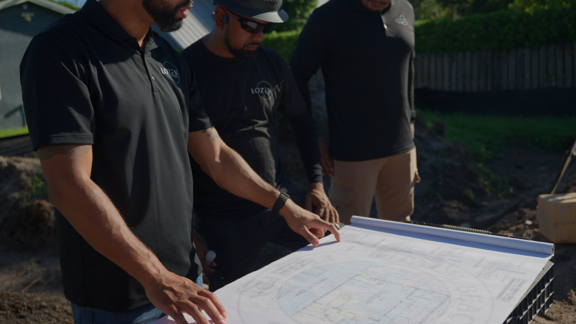Lozen Development team reviewing foundation plans on site